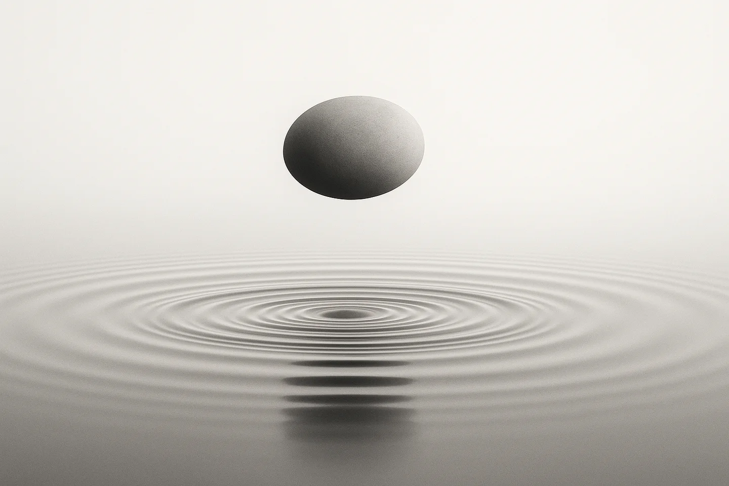 Minimalist illustration of a rounded stone suspended above concentric ripples in water.